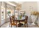 Dining area featuring a round table, chandelier, large window and upscale decor at 15377 W Cheery Lynn Rd, Goodyear, AZ 85395