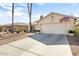 Charming single-story home featuring a two-car garage, desert landscaping, and neutral exterior paint at 15377 W Cheery Lynn Rd, Goodyear, AZ 85395