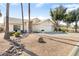 Charming single-story home boasting a well-manicured front yard, desert landscaping, and an attached two-car garage at 15377 W Cheery Lynn Rd, Goodyear, AZ 85395