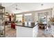 Open-concept kitchen with a center island that flows into the dining and living areas at 15377 W Cheery Lynn Rd, Goodyear, AZ 85395