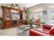 Elegant living room features stone floors, a large cabinet, and a big window, creating an inviting and stylish space at 15377 W Cheery Lynn Rd, Goodyear, AZ 85395