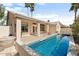 Backyard pool with patio and view of the house featuring a covered seating area at 15377 W Cheery Lynn Rd, Goodyear, AZ 85395