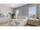 Cozy main bedroom with stylish furnishings, neutral tones, and natural light from the windows at 15474 W Cottontail Ln, Surprise, AZ 85387