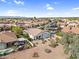 Expansive aerial view showcasing the neighborhood with pools and lush landscaping at 15563 W Roanoke Ave, Goodyear, AZ 85395