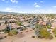 Wide aerial view highlighting community homes with pools, solar panels, and landscaping at 15563 W Roanoke Ave, Goodyear, AZ 85395