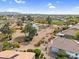 Community aerial view features a scenic pond and well-maintained green spaces at 15563 W Roanoke Ave, Goodyear, AZ 85395