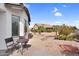 A meticulously landscaped backyard features desert plants, rock features, and a cozy seating area at 15563 W Roanoke Ave, Goodyear, AZ 85395