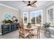 Dining area bathed in natural light with plantation shutters, stylish decor, and cozy atmosphere at 15563 W Roanoke Ave, Goodyear, AZ 85395