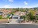 Aerial view of a home with a well-maintained lawn, desert landscaping, and a two-car garage at 15563 W Roanoke Ave, Goodyear, AZ 85395