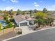 Aerial view of a well-maintained home with manicured desert landscaping and a neatly paved driveway at 15563 W Roanoke Ave, Goodyear, AZ 85395