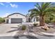 Charming single-story home with a two-car garage, desert landscaping, and a welcoming front porch at 15563 W Roanoke Ave, Goodyear, AZ 85395