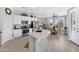 Bright kitchen featuring white cabinetry, stainless steel appliances, and an open layout with an adjacent dining area at 15563 W Roanoke Ave, Goodyear, AZ 85395