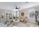 Inviting living room boasts plantation shutters, neutral tones, comfortable seating, and ample natural light at 15563 W Roanoke Ave, Goodyear, AZ 85395