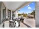 Covered patio with comfortable seating and outdoor dining, overlooking manicured landscaping at 15563 W Roanoke Ave, Goodyear, AZ 85395