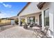 Covered patio featuring an outdoor dining and seating area with desert landscaping at 15563 W Roanoke Ave, Goodyear, AZ 85395