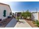 Spacious backyard patio area with shade trees, pergola and dining set. A lovely space for outdoor relaxation at 16438 W Mescal St, Surprise, AZ 85388