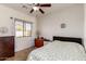 Comfortable bedroom with natural light, a ceiling fan, and tile flooring at 16438 W Mescal St, Surprise, AZ 85388