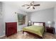 Cozy bedroom with large window, ceiling fan, and tile floors at 16438 W Mescal St, Surprise, AZ 85388