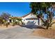 Charming single-story home with desert landscaping, arched entry and two-car garage at 16438 W Mescal St, Surprise, AZ 85388