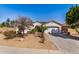 Charming single-story home with desert landscaping, arched entry and two-car garage at 16438 W Mescal St, Surprise, AZ 85388