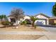 Charming single-story home with desert landscaping, arched entry and two-car garage at 16438 W Mescal St, Surprise, AZ 85388