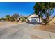 Charming single-story home with desert landscaping, arched entry and two-car garage at 16438 W Mescal St, Surprise, AZ 85388