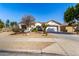 Charming single-story home with desert landscaping, arched entry and two-car garage at 16438 W Mescal St, Surprise, AZ 85388