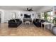 Spacious living room featuring tile floors, a ceiling fan, and bright natural light at 16438 W Mescal St, Surprise, AZ 85388