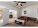 Cozy living room features a ceiling fan, comfortable couches, and access to other rooms at 16438 W Mescal St, Surprise, AZ 85388