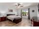 Main bedroom featuring a ceiling fan, a window with natural light, and tile floors at 16438 W Mescal St, Surprise, AZ 85388