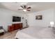 Spacious main bedroom featuring a ceiling fan, large dresser, and neutral color palette at 16438 W Mescal St, Surprise, AZ 85388