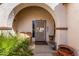 Cozy covered front porch with seating, potted plants and a security door at 16438 W Mescal St, Surprise, AZ 85388