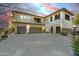 Two-story beige stucco home featuring dual garages and private balconies, set against a colorful twilight sky at 16800 E El Lago Blvd # 2072, Fountain Hills, AZ 85268