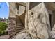 Exterior stairs leading to the condo entrance with stone accents and stucco walls at 16800 E El Lago Blvd # 2072, Fountain Hills, AZ 85268