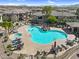 Community pool featuring rock features, hot tub, lounge chairs, tables, and desert landscaping at 16800 E El Lago Blvd # 2072, Fountain Hills, AZ 85268