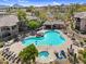 Aerial view of community pool with rock features, hot tub, lounge chairs and desert landscaping at 16800 E El Lago Blvd # 2072, Fountain Hills, AZ 85268