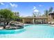 Inviting pool featuring a rock waterfall and a covered outdoor dining area for poolside enjoyment at 16800 E El Lago Blvd # 2072, Fountain Hills, AZ 85268