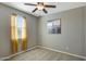 Simple bedroom featuring a window, neutral walls, and soft carpeting, providing a serene retreat at 16881 W Monroe St, Goodyear, AZ 85338