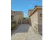 View of long driveway made of pavers and gated access to the property and backyard at 16881 W Monroe St, Goodyear, AZ 85338