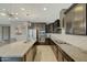 Modern kitchen featuring granite countertops, sleek black cabinets, and stainless steel appliances at 16881 W Monroe St, Goodyear, AZ 85338