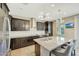 Modern kitchen featuring granite countertops, sleek black cabinets, and stainless steel appliances at 16881 W Monroe St, Goodyear, AZ 85338