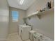 Laundry room with washer, dryer, shelving, and storage baskets at 16881 W Monroe St, Goodyear, AZ 85338