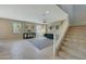 Open-concept living room features tile flooring, contemporary decor, and a staircase, perfect for entertaining at 16881 W Monroe St, Goodyear, AZ 85338