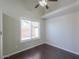 A bedroom featuring hardwood floors, a window, and ceiling fan at 1753 E Shasta St, Casa Grande, AZ 85122