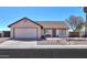 Charming single-story home with a well-manicured desert landscape and attached two-car garage at 1753 E Shasta St, Casa Grande, AZ 85122