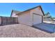 Side view of the home showcasing the attached two-car garage and fenced yard at 1753 E Shasta St, Casa Grande, AZ 85122