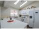 Bright kitchen featuring modern appliances, a breakfast bar, and stone backsplash at 1753 E Shasta St, Casa Grande, AZ 85122