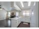 Well-lit kitchen with white appliances, stone backsplash and a breakfast bar at 1753 E Shasta St, Casa Grande, AZ 85122