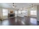 Open-concept living room featuring wood floors, a fireplace, and a view into the kitchen at 1753 E Shasta St, Casa Grande, AZ 85122