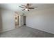 Bright main bedroom with neutral walls, a ceiling fan, and access to the ensuite bathroom at 1753 E Shasta St, Casa Grande, AZ 85122